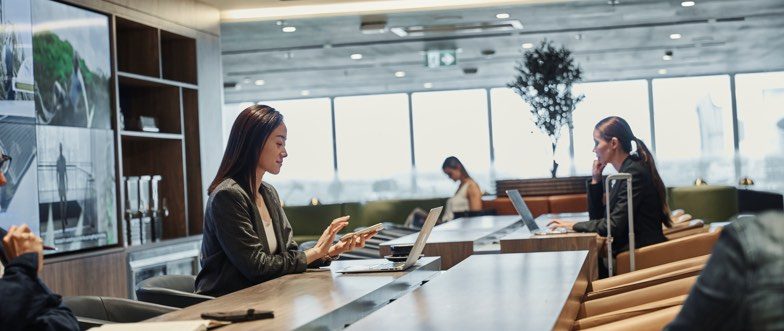 Woman sitting at amex lounge sydney airport content