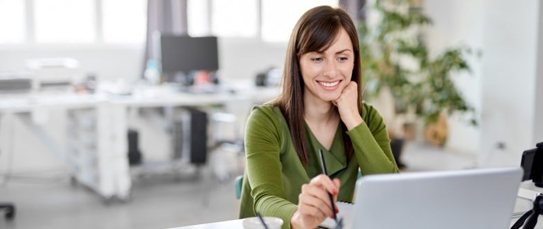 Woman at computer wearing green shirt content