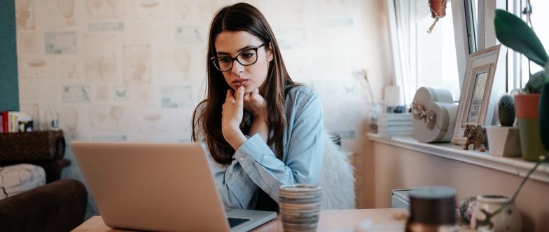 Woman looking at life insurance for family on laptop content