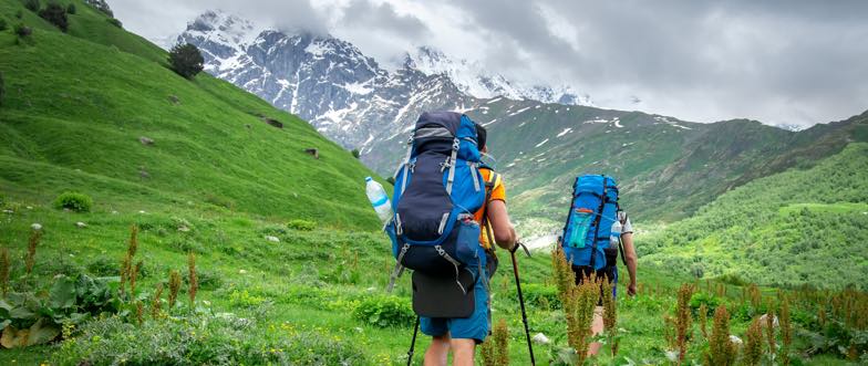 Two hikers walking in the mountains content
