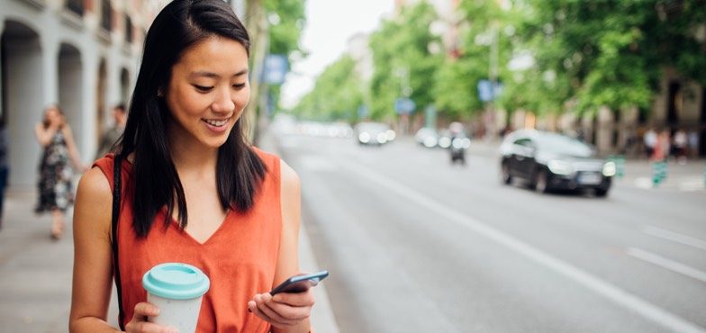Woman checking savings account rates on phone content