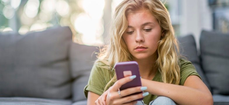 Australian woman checking emails to avoid being scammed content
