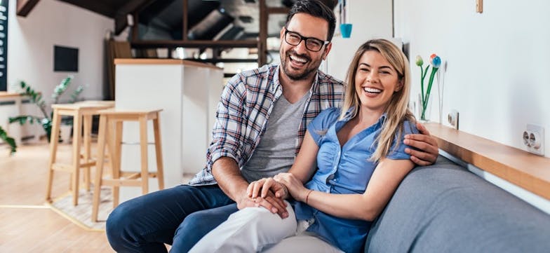 Laughing couple apartment article image content
