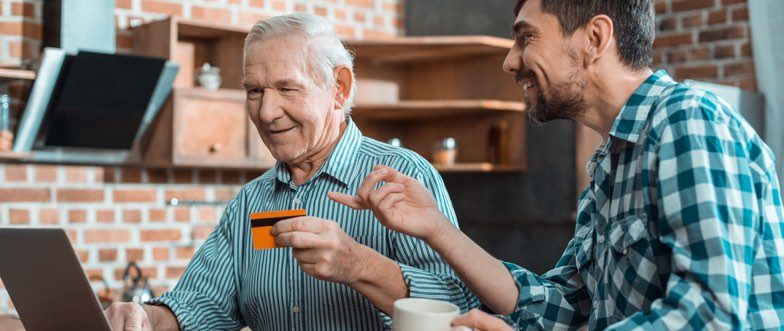 Son helping father with new debit card content