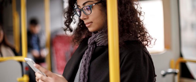 Woman looking at xinja savings account rate change on her phone content