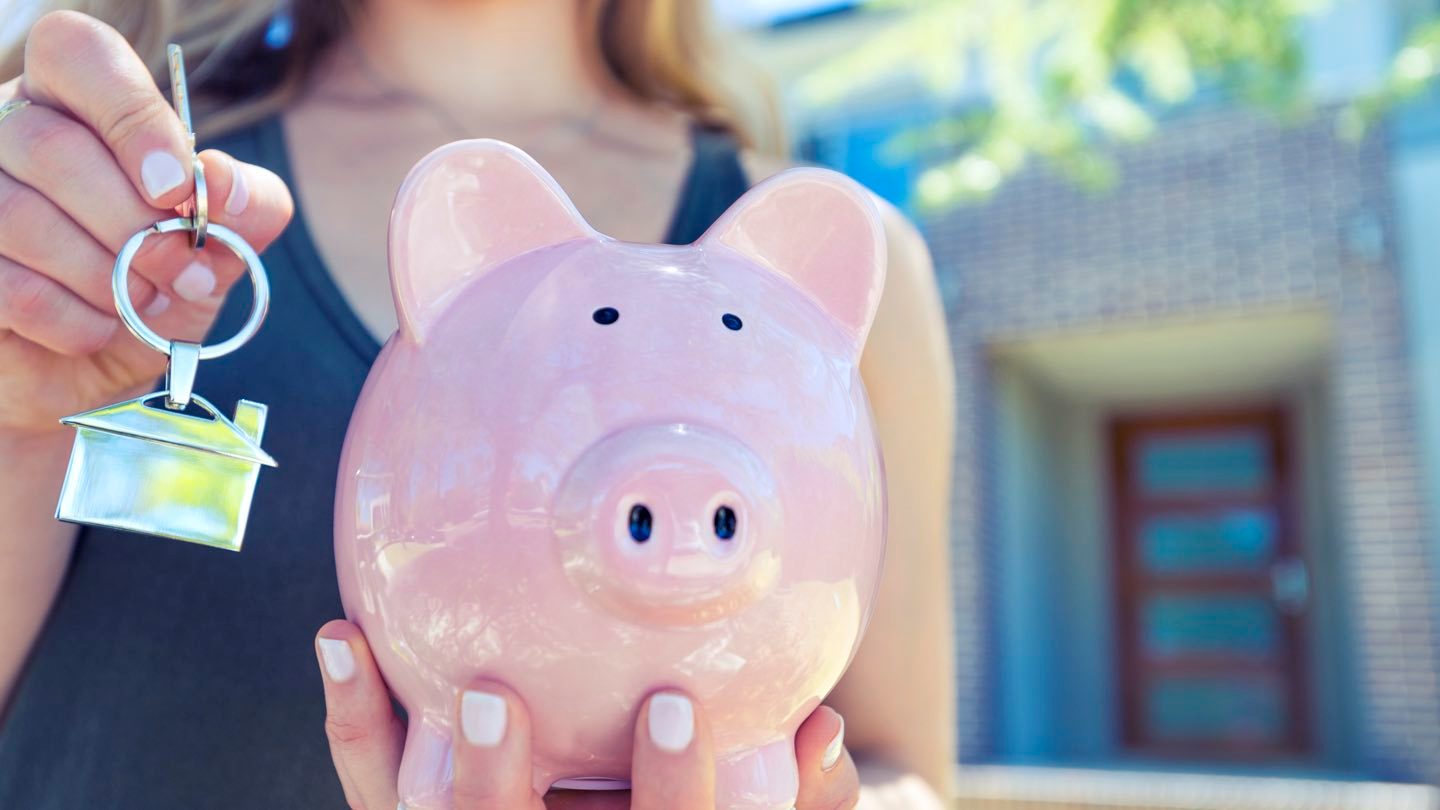 Woman outside house with piggybank article image content