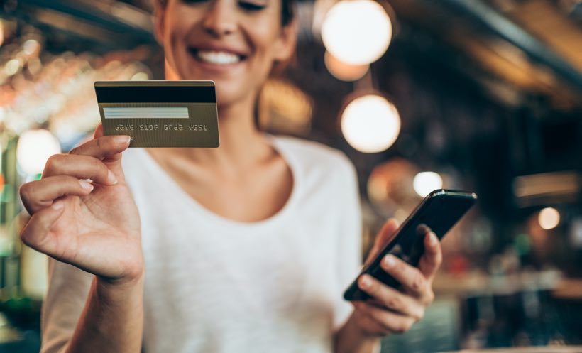 Woman using gold card cafe article image content