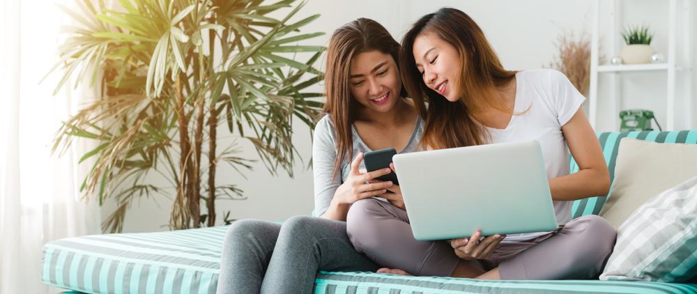People women couple with laptop on couch content