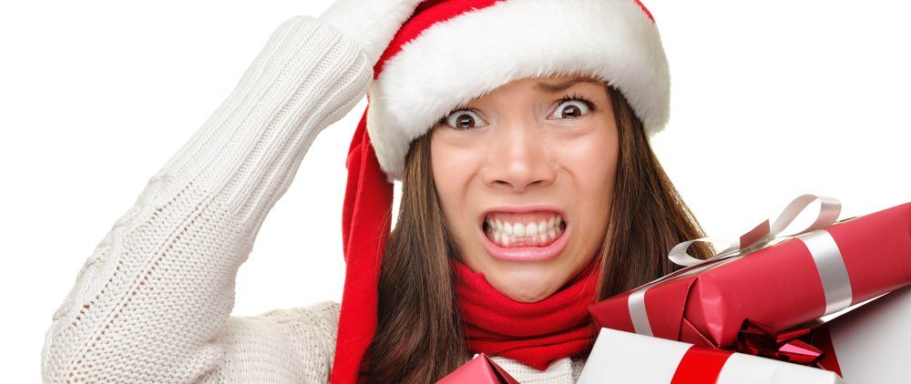 Person woman holiday christmas gift reaction oh no a woman holding gifts wearing a snata hand looking concerned content