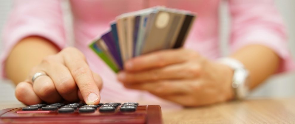 Person woman money card a woman using a red calculater holding credit cards content