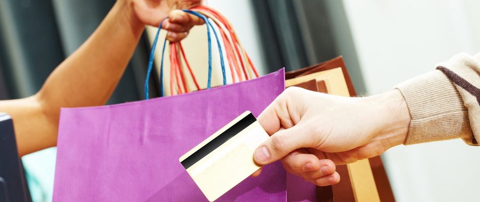 Money credit card hand a hand handing over a credit card to get some bags of shopping content