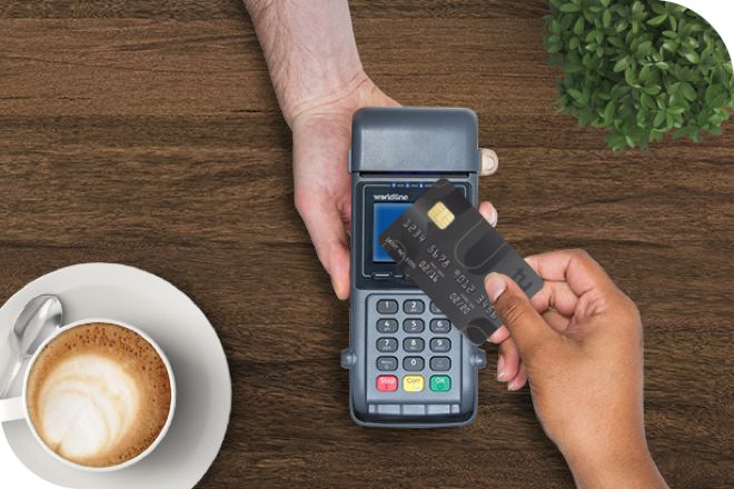 Tapping Apple Watch on eftpos machine, cafe owner is paying less in merchant transaction fees.