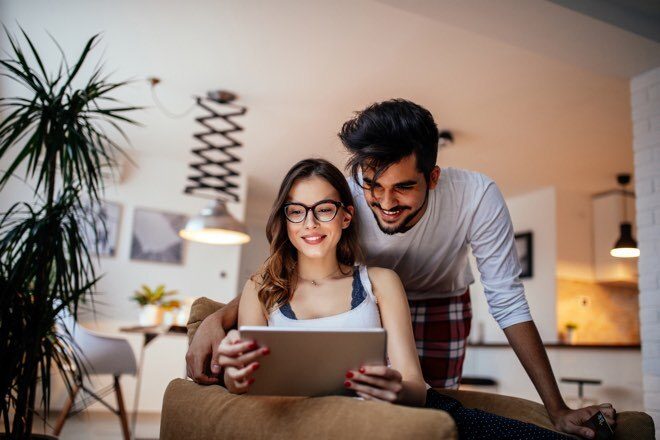 Couple at home on a tablet looking up renters insurance