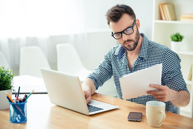 Man concentrating, reading product disclosure statement.