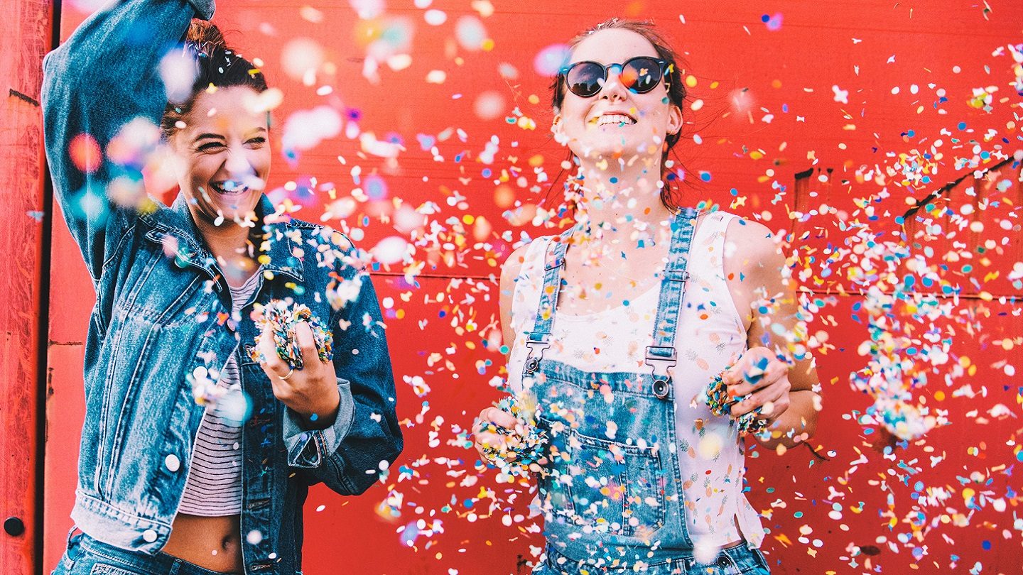 Young women with confetti celebrating savings, freebies and discounts