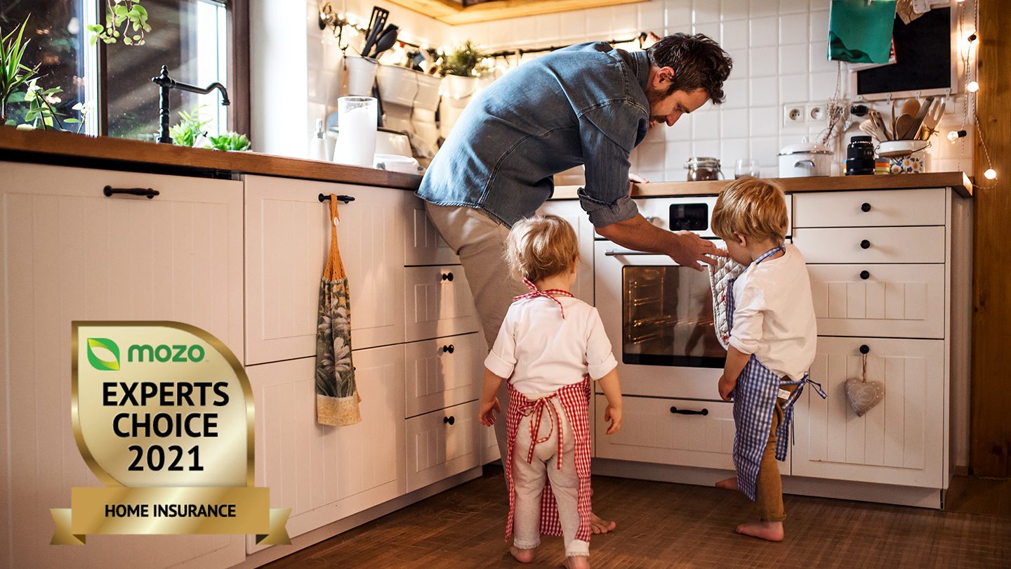 Parent showing children something in kitchen after taking out a top home insurance policy.