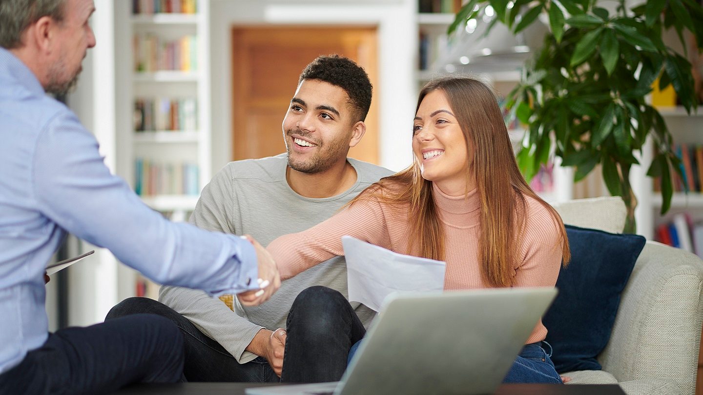 Couple shaking hands with home lender