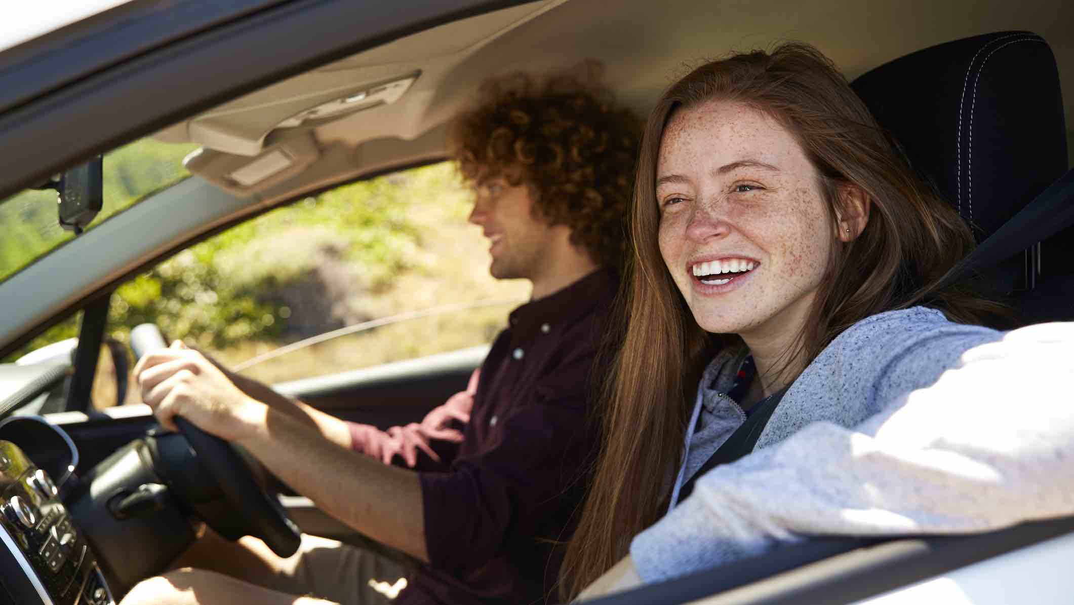 Young people driving in a car with the best car insurance in Australia.