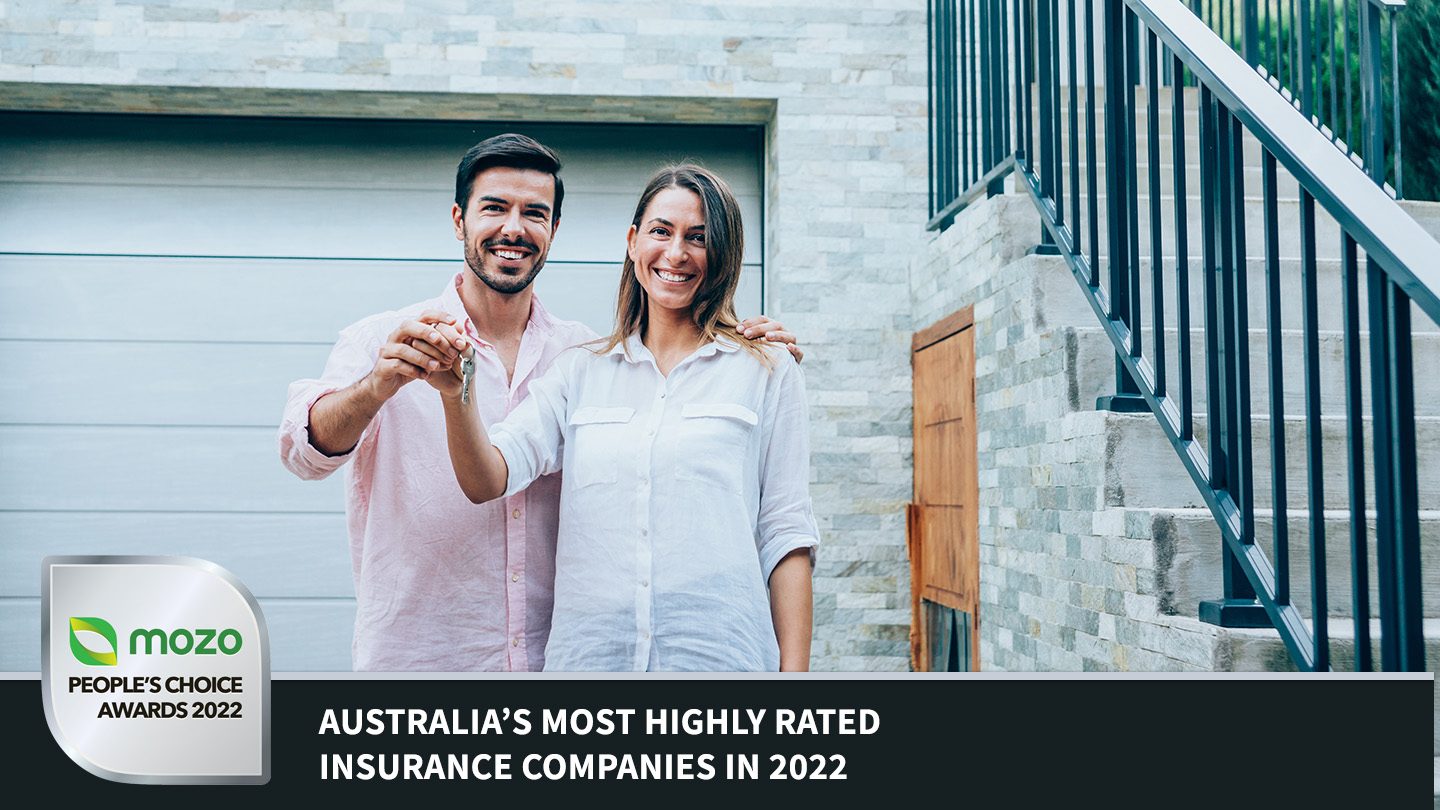 Man and woman holding keys in front of house. Mozo People's Choice 2022 banner below for highly rated insurance providers.