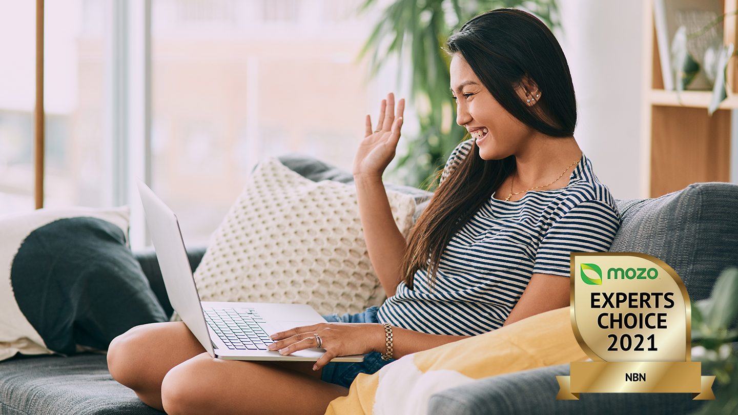 Woman using a laptop and great NBN plan to video call friends.