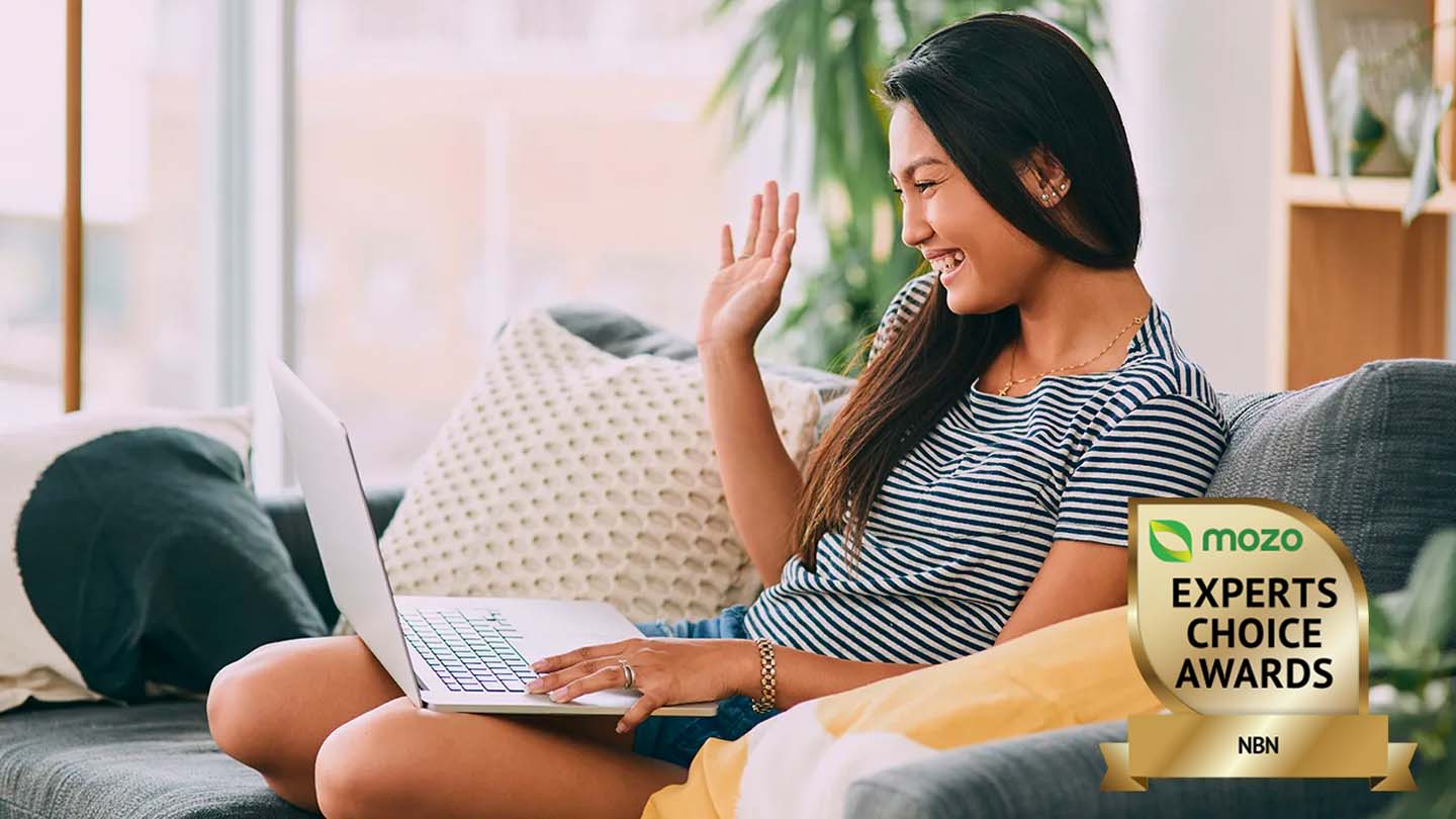 Woman using a laptop and great NBN plan to video call friends.