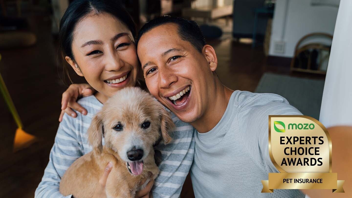 couple hugging their dog