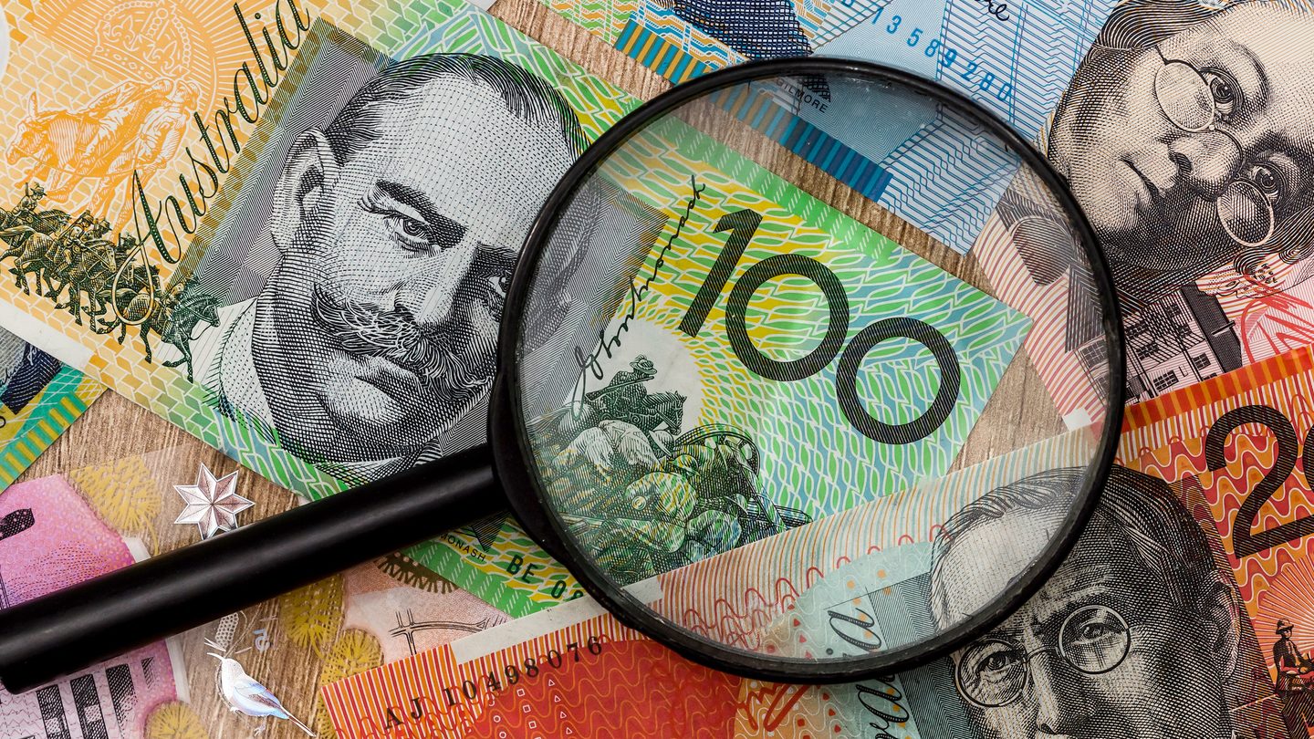 close up magnifying glass on australian money saved through good personal loan management