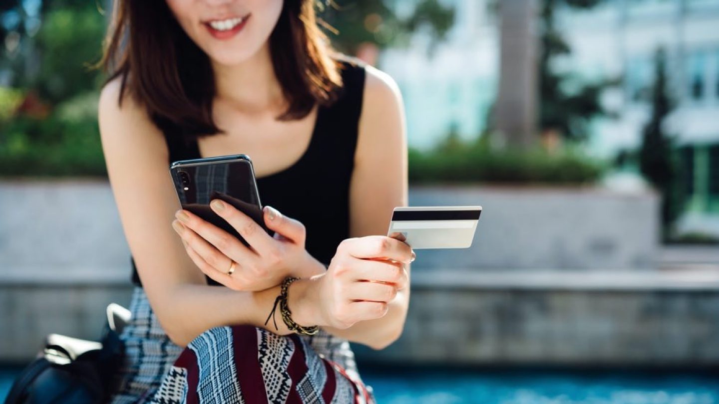 woman-holding-credit-card-and-phone