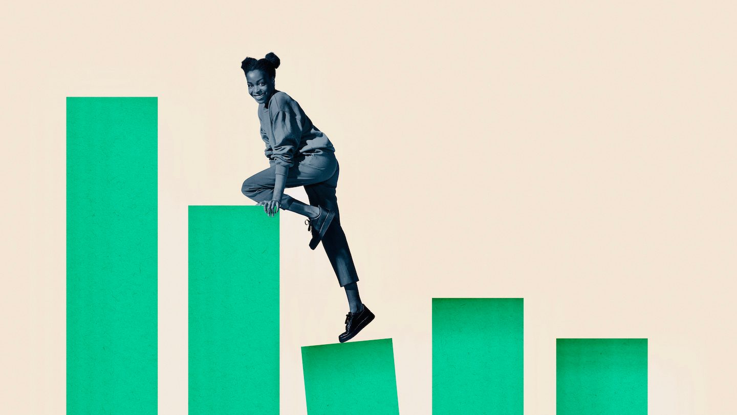 A cheeky woman climbs green money bars.