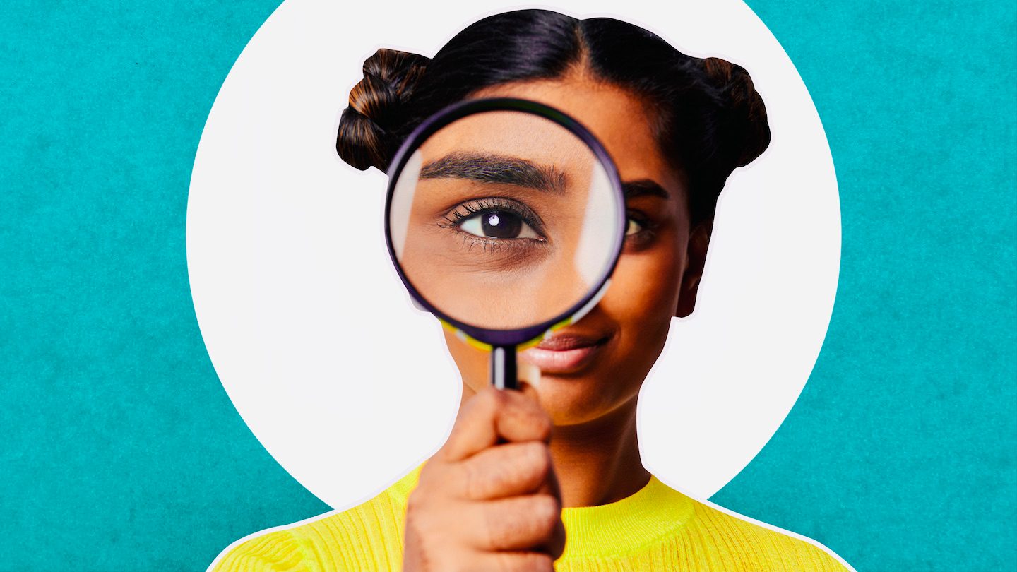 A woman holds up a magnifying glass. Green and white background.