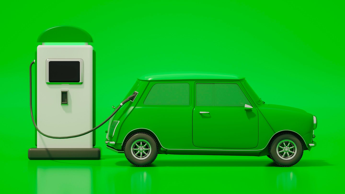 A green model car refuels at a green pump.