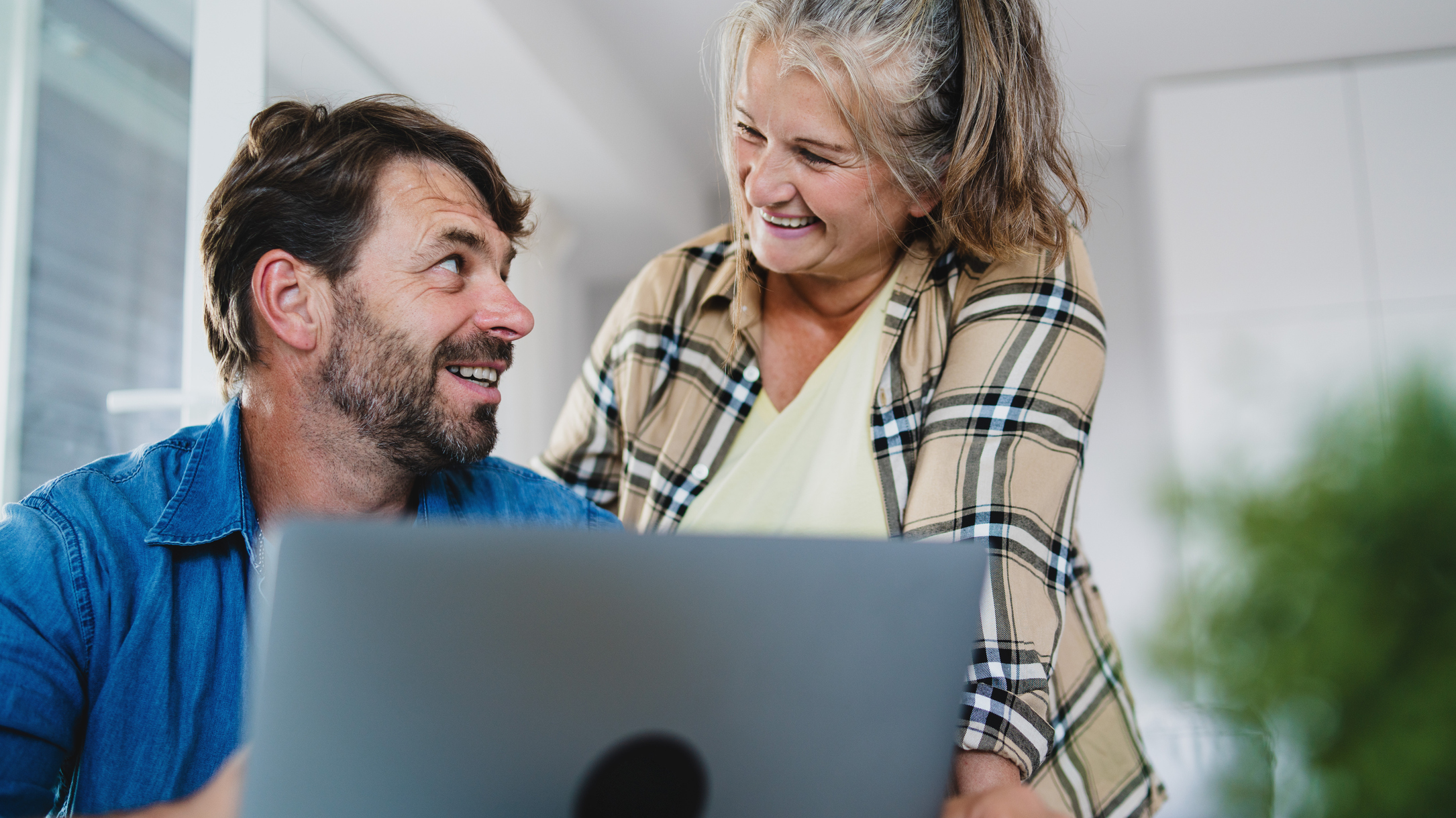 A happy mature couple on their laptop.
