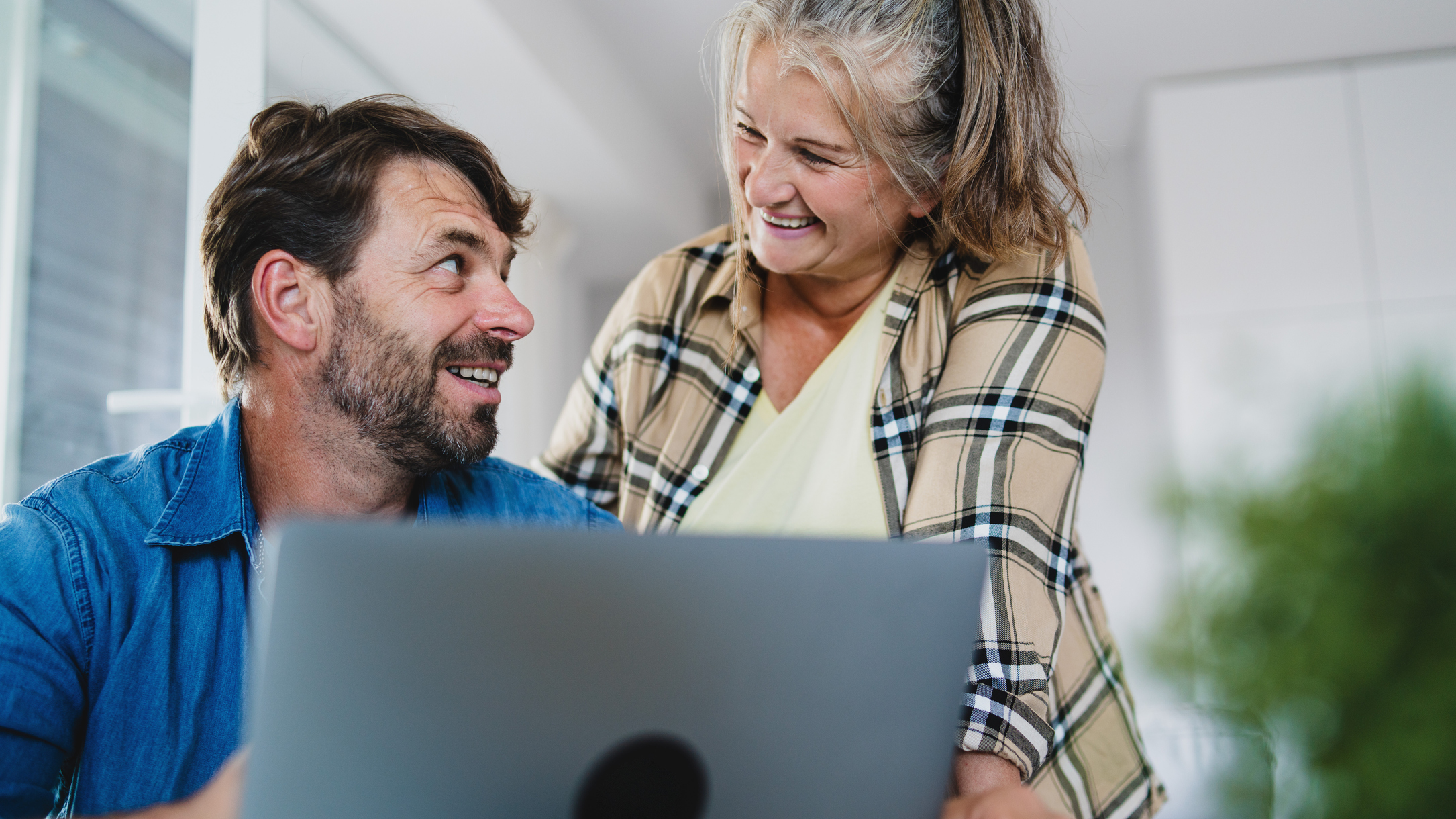 A happy mature couple on their laptop. 