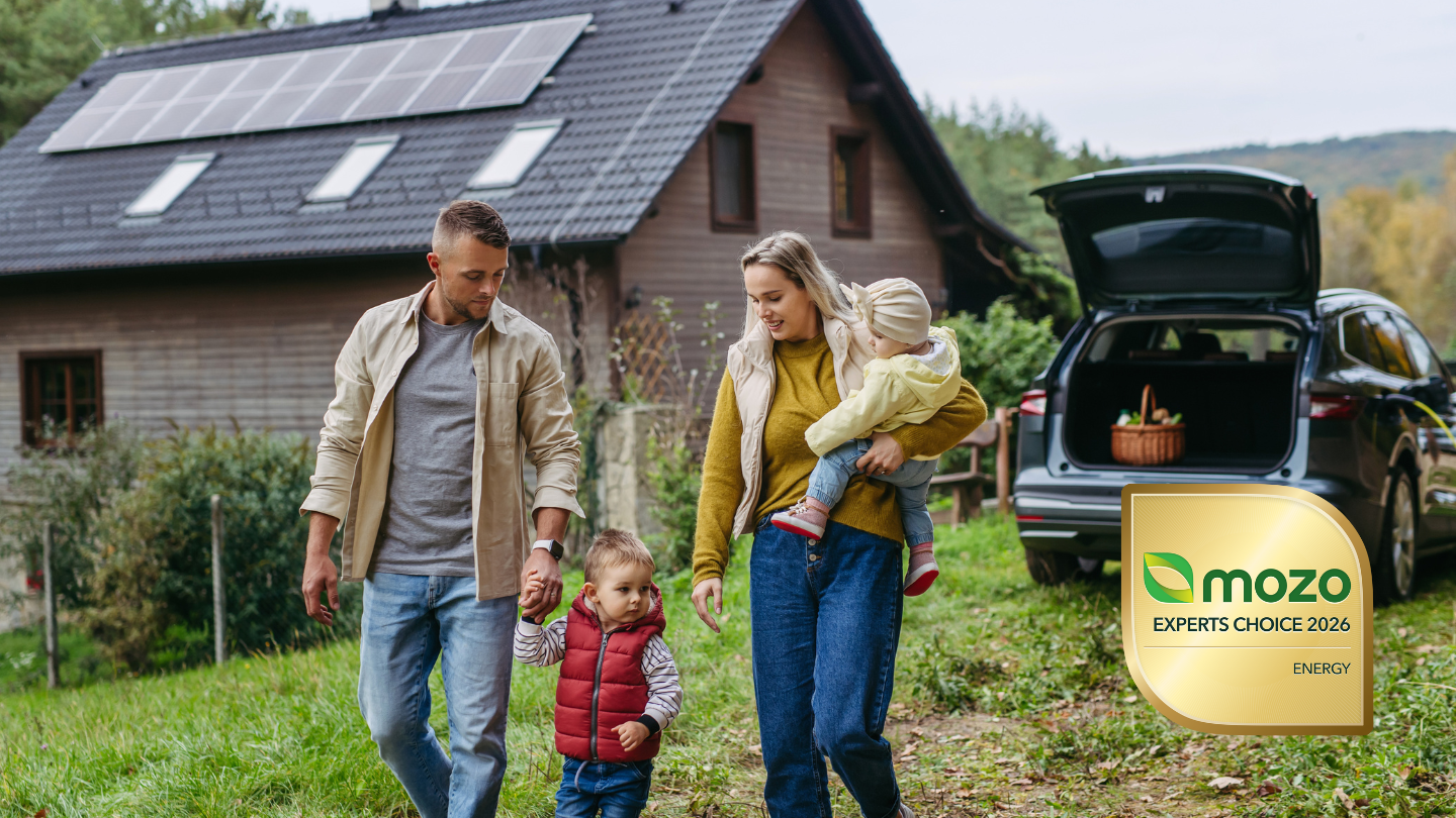 Family outside their home with solar panels next to Mozo Experts Choice Awards 2026 badge for Energy