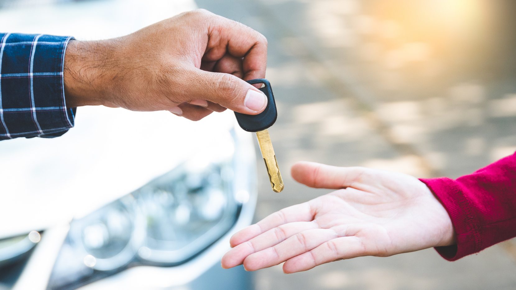 man-selling-car-with-outstanding-loan-handing-over-keys