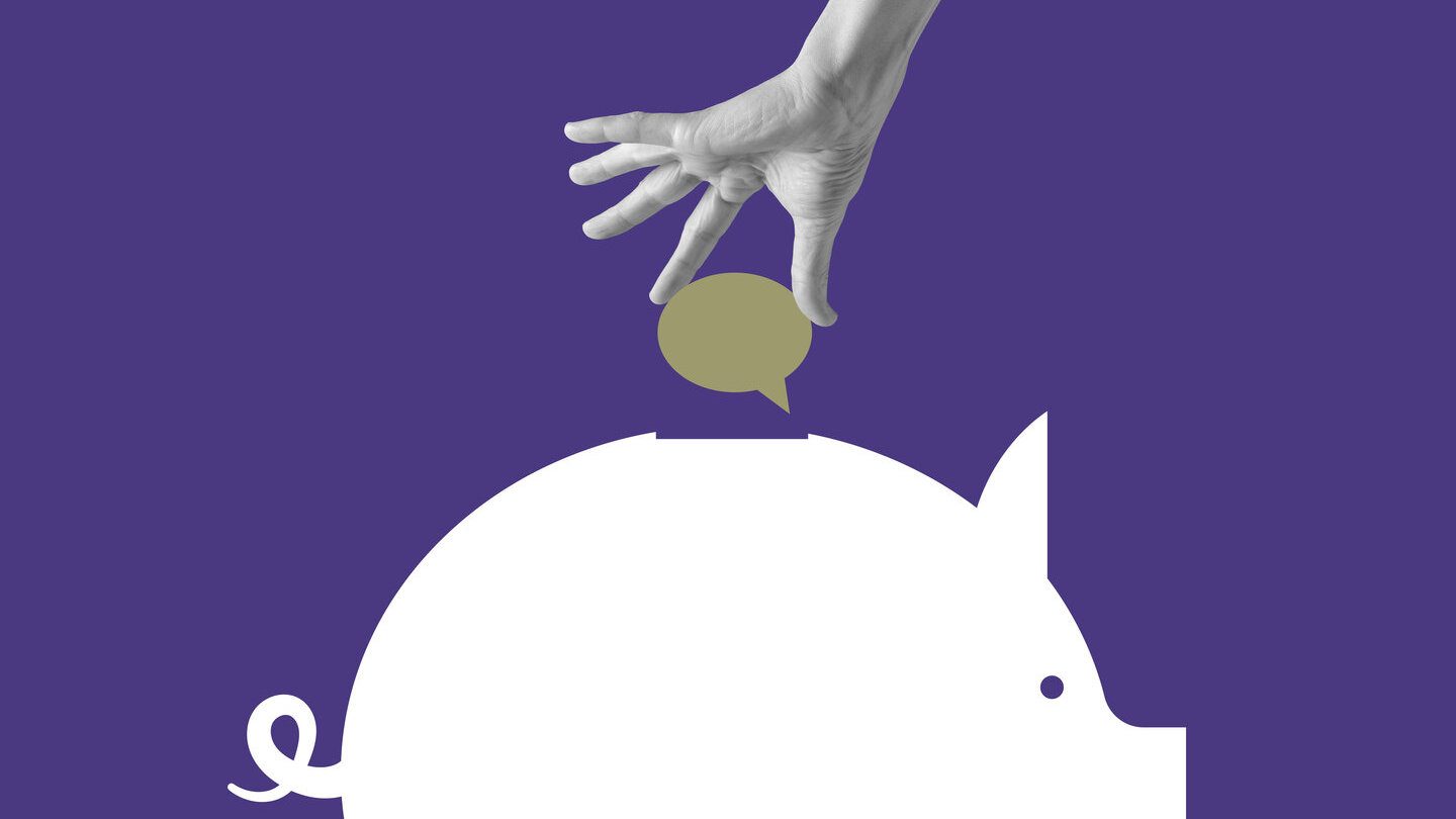 a hand putting a speech bubble into a piggy bank